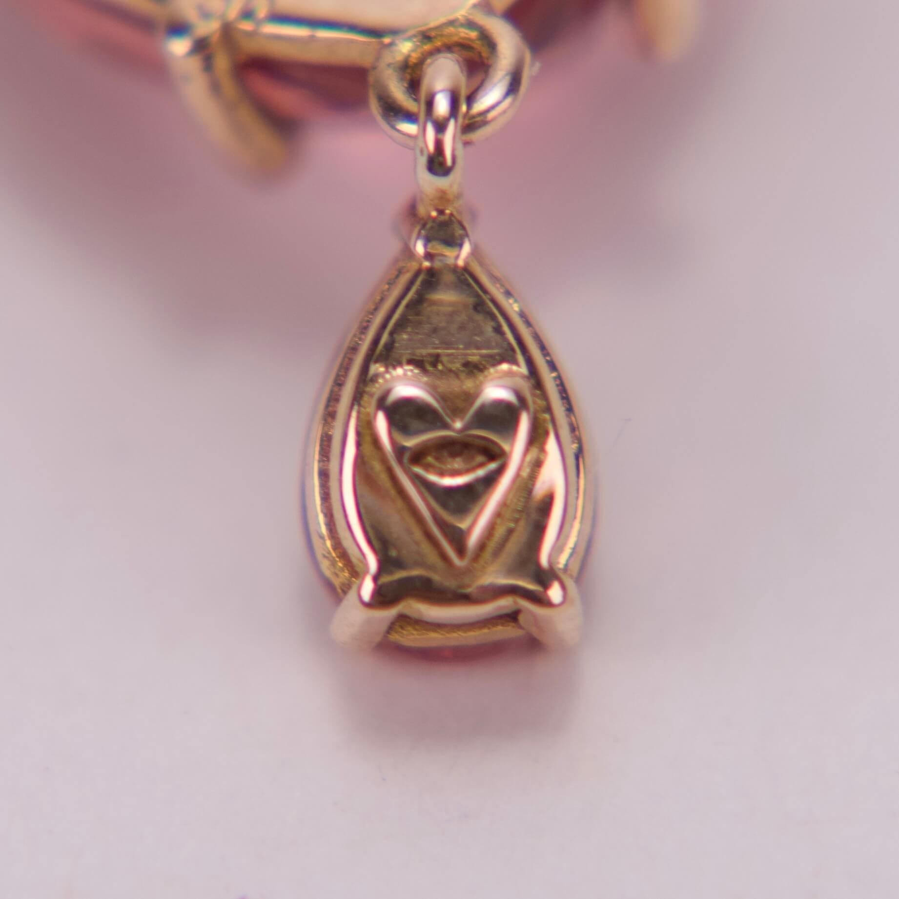 Gold heart-shaped pendant with intricate design.