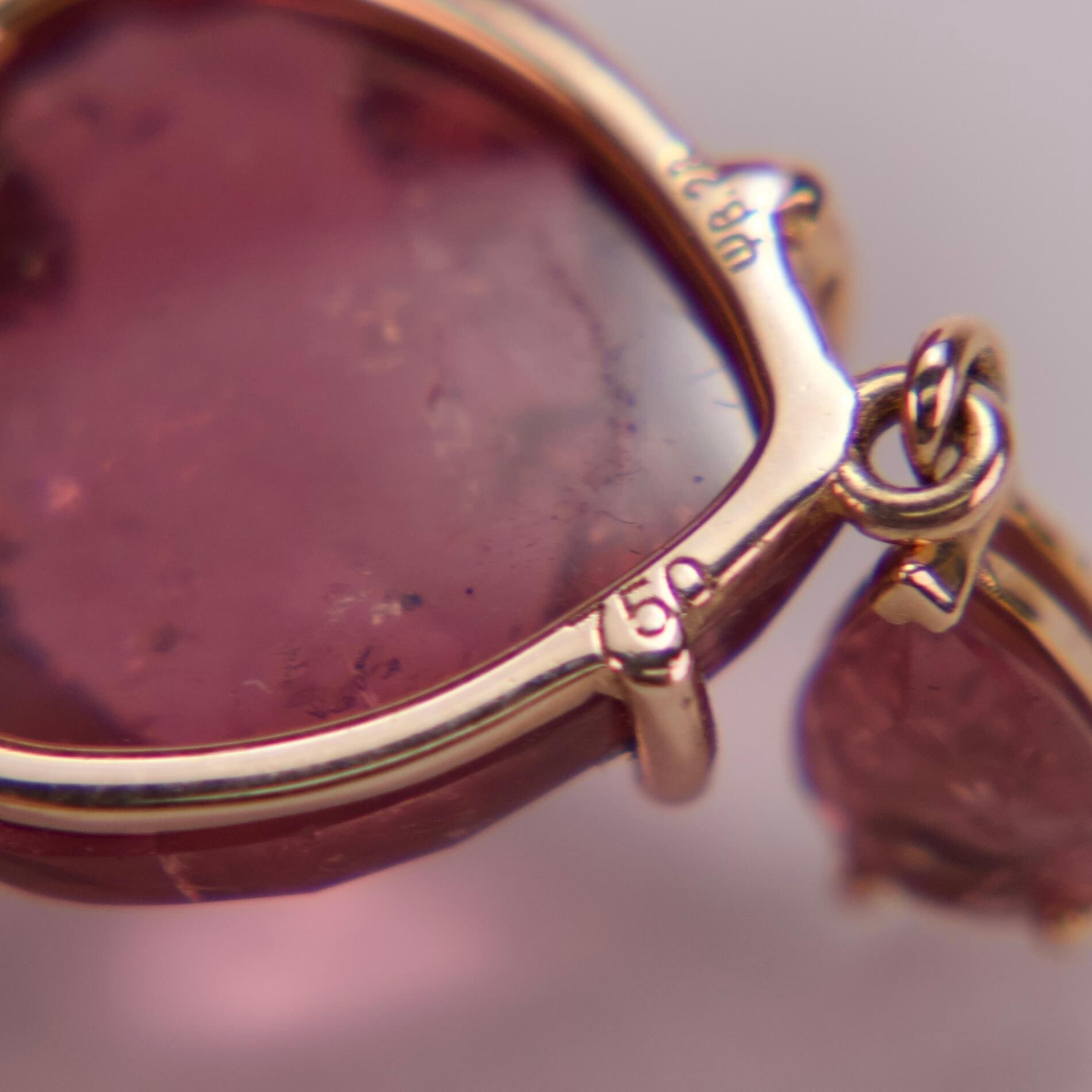 Close-up of a pink gemstone pendant.