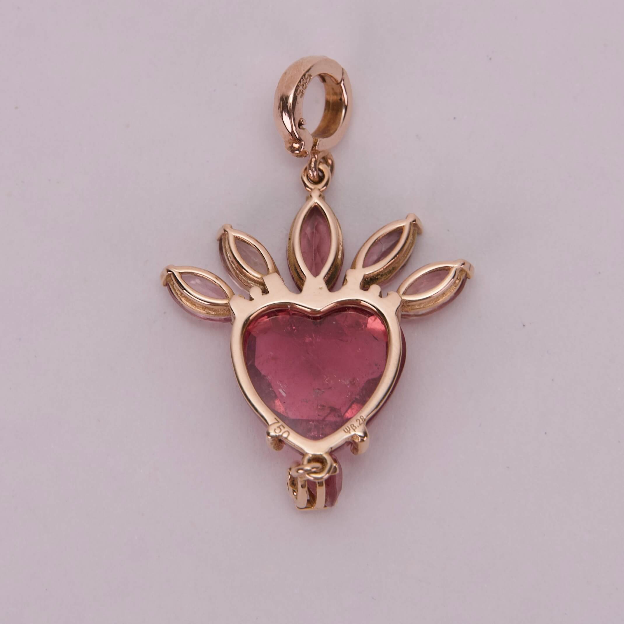 Heart-shaped red gemstone pendant design.
