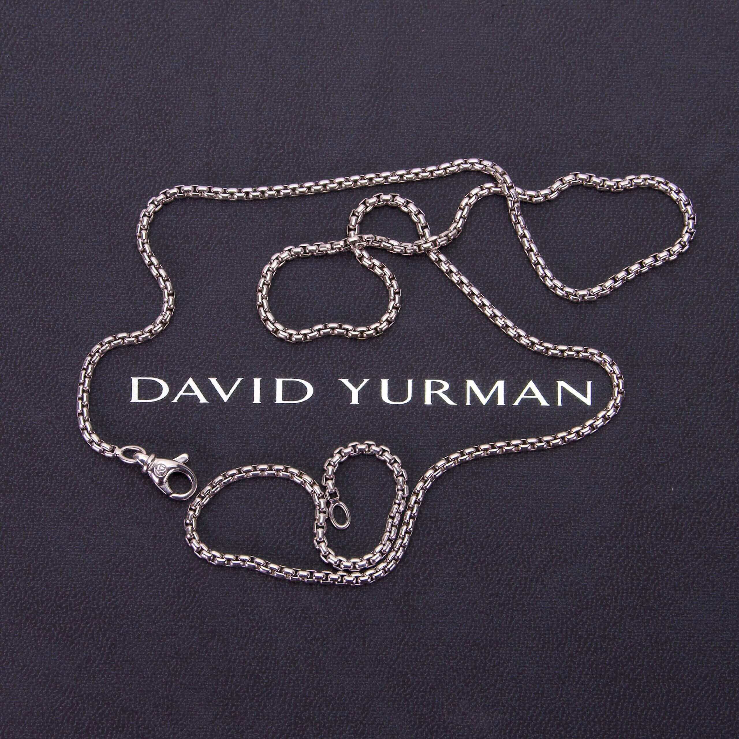 Silver chain on David Yurman branded background.
