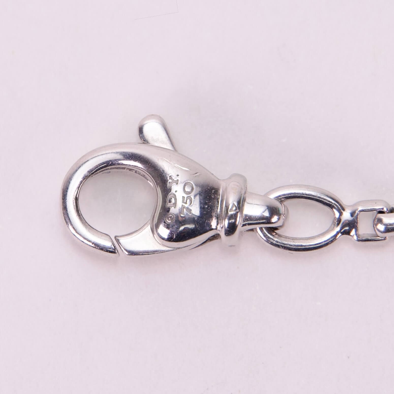 Silver lobster clasp on a white background.