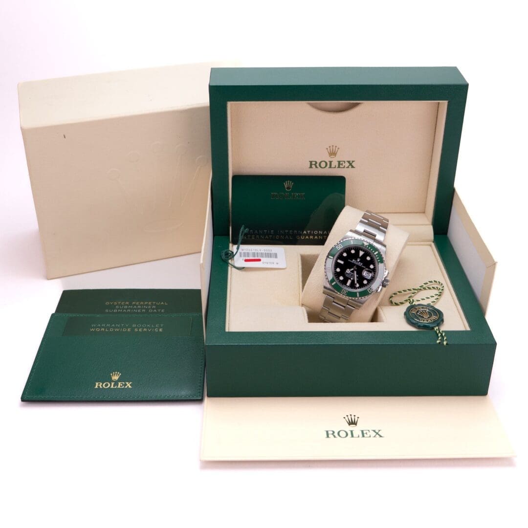 Rolex watch in green box with documents.