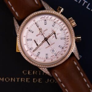 Luxury watch with diamond bezel and leather strap.