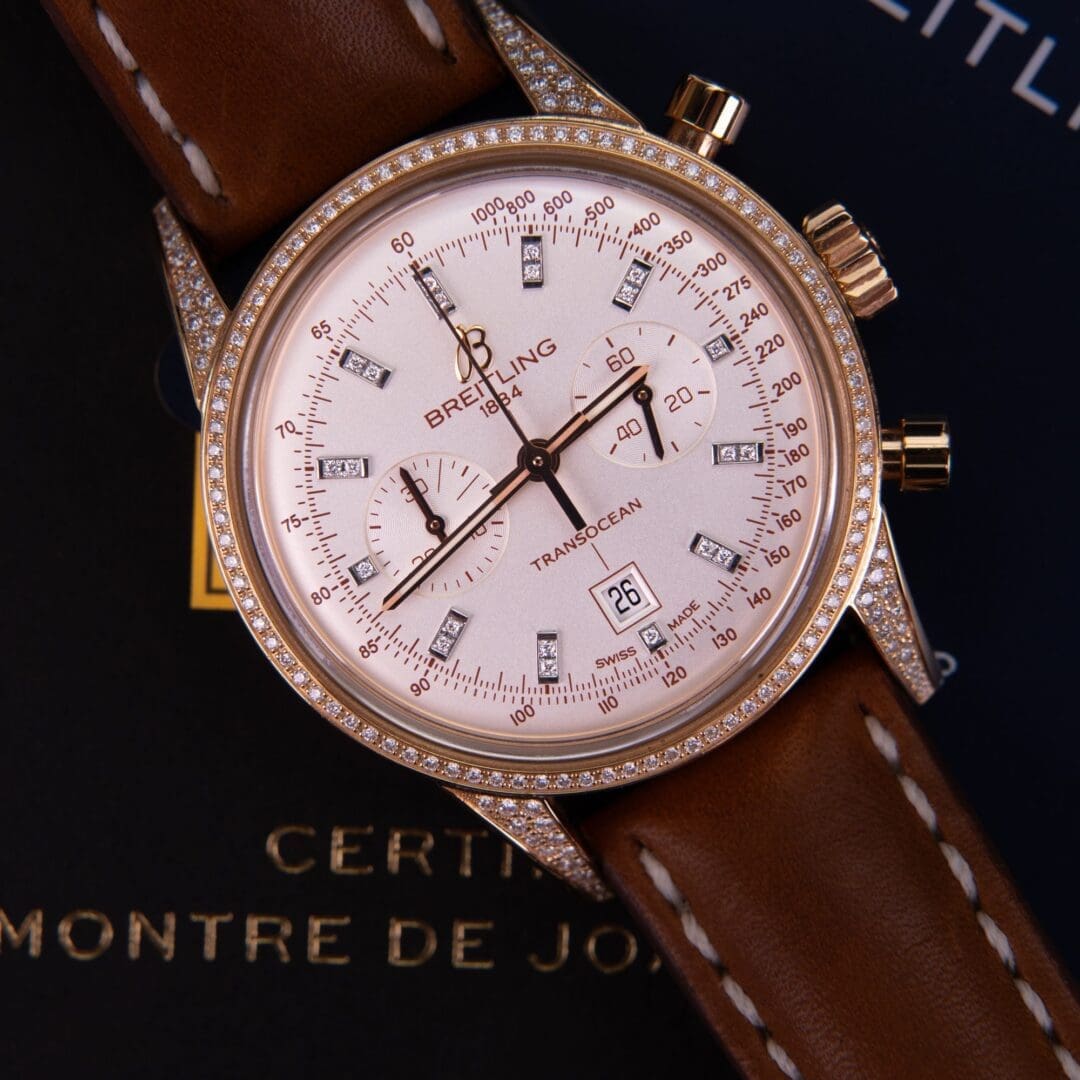 Luxury watch with diamond bezel and leather strap.