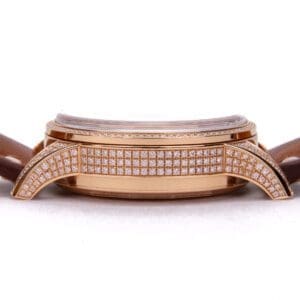 Gold watch with diamond accents and strap.