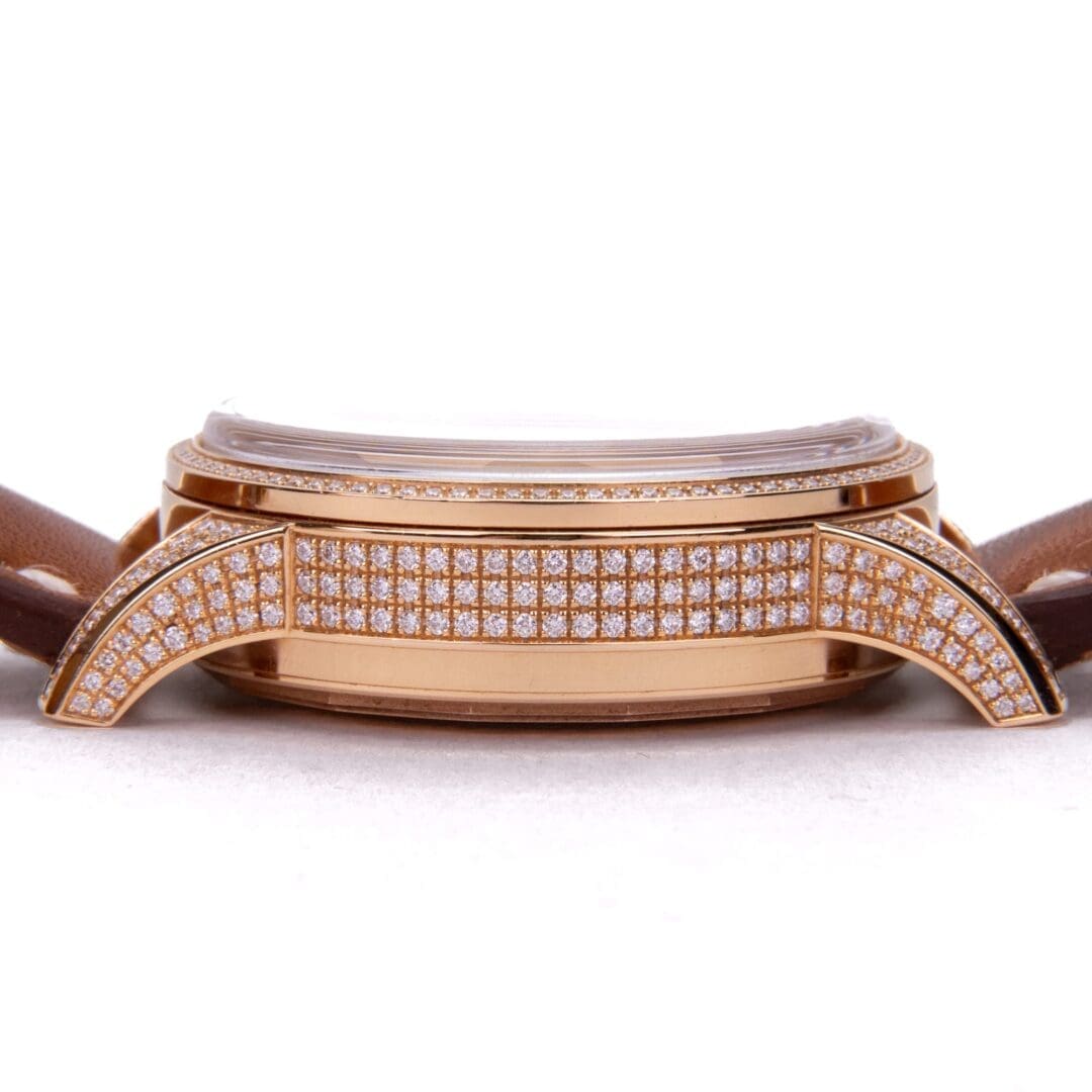 Gold watch with diamond accents and strap.