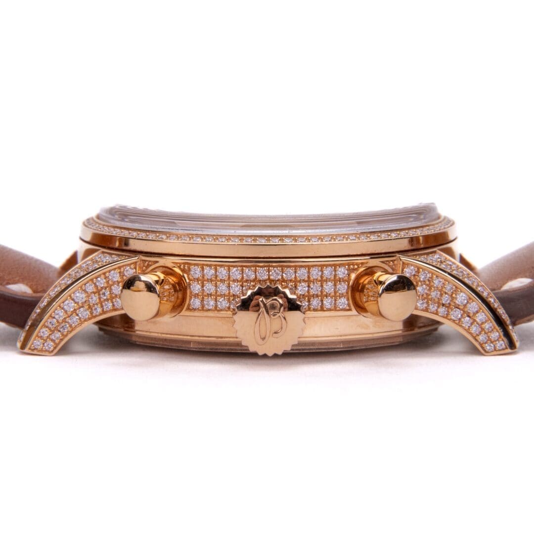 Luxurious diamond-encrusted gold watch with leather strap.
