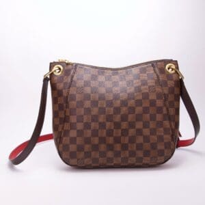 Brown checkered handbag with shoulder strap.