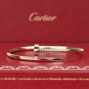 Gold bracelet on red Cartier box.