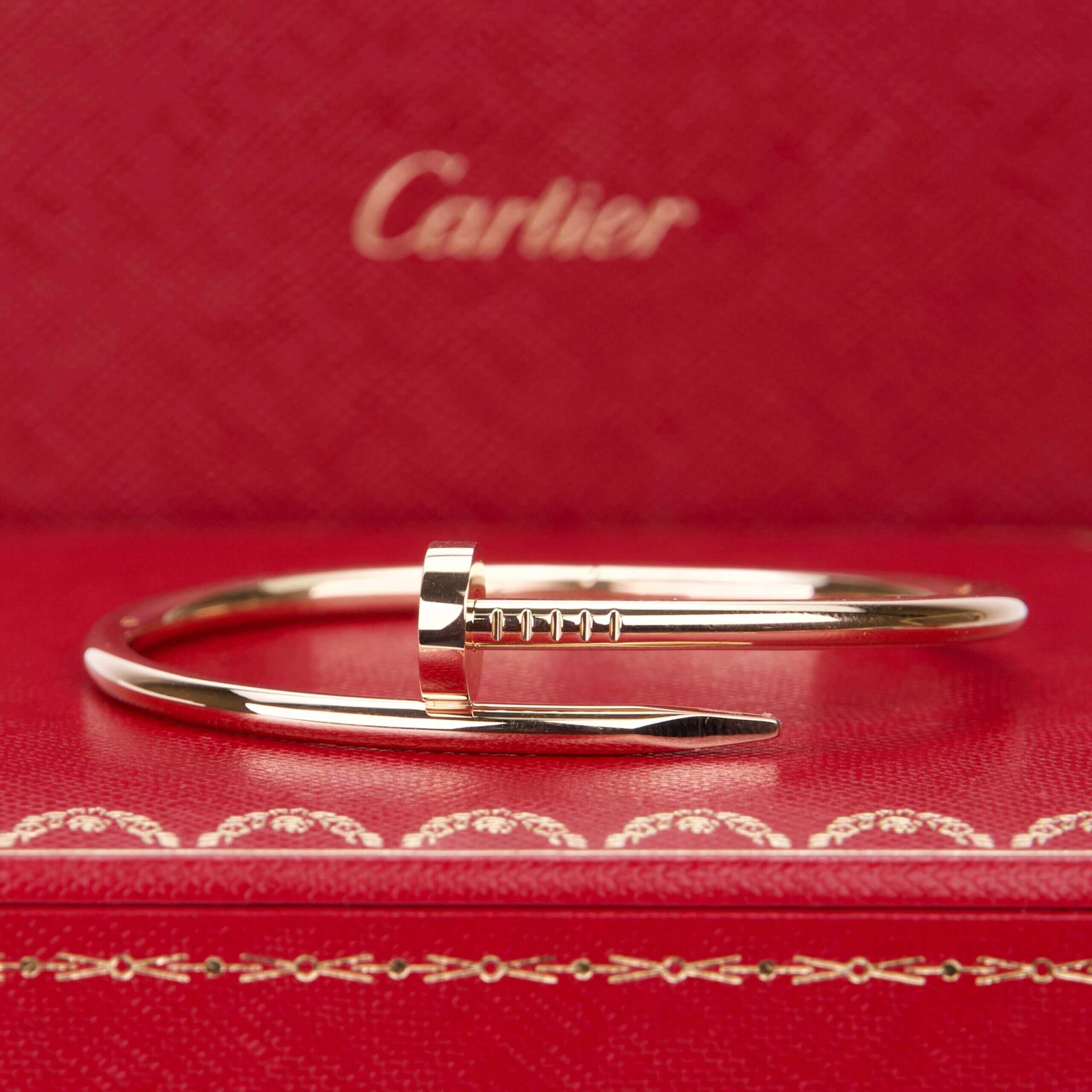 Gold bracelet on red Cartier box.