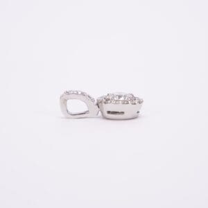 Silver diamond pendant on white background.