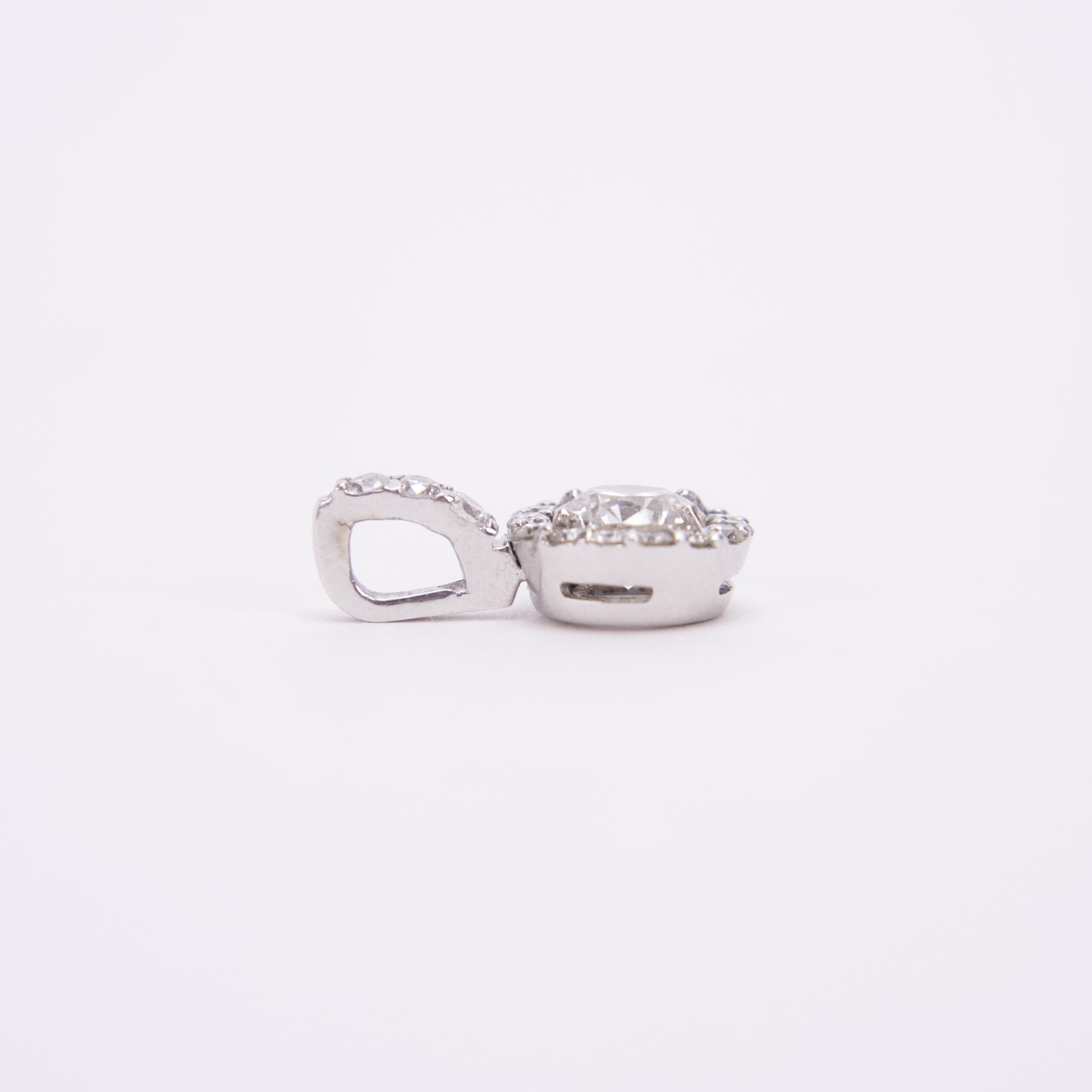 Silver diamond pendant on white background.