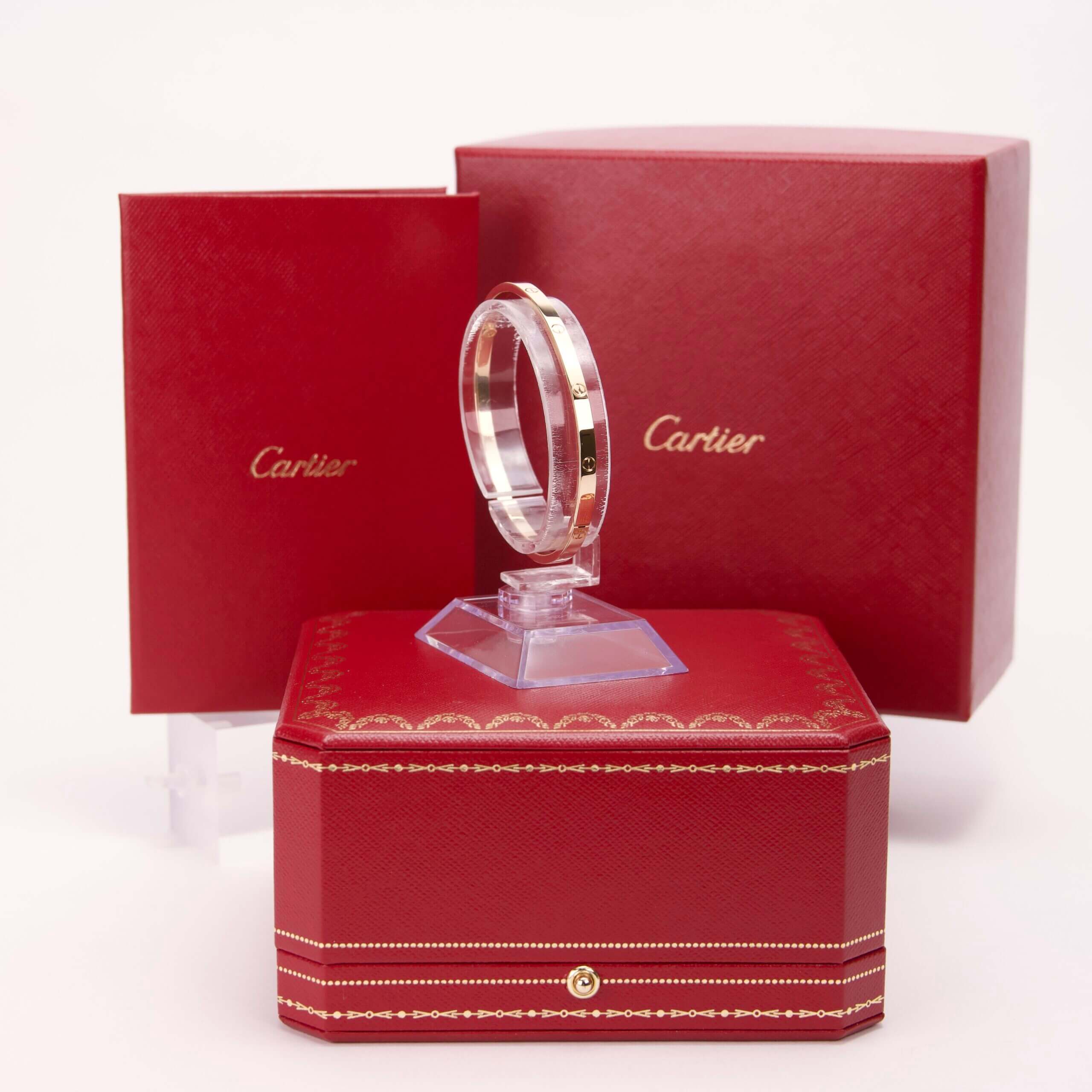 Cartier ring with red packaging boxes.