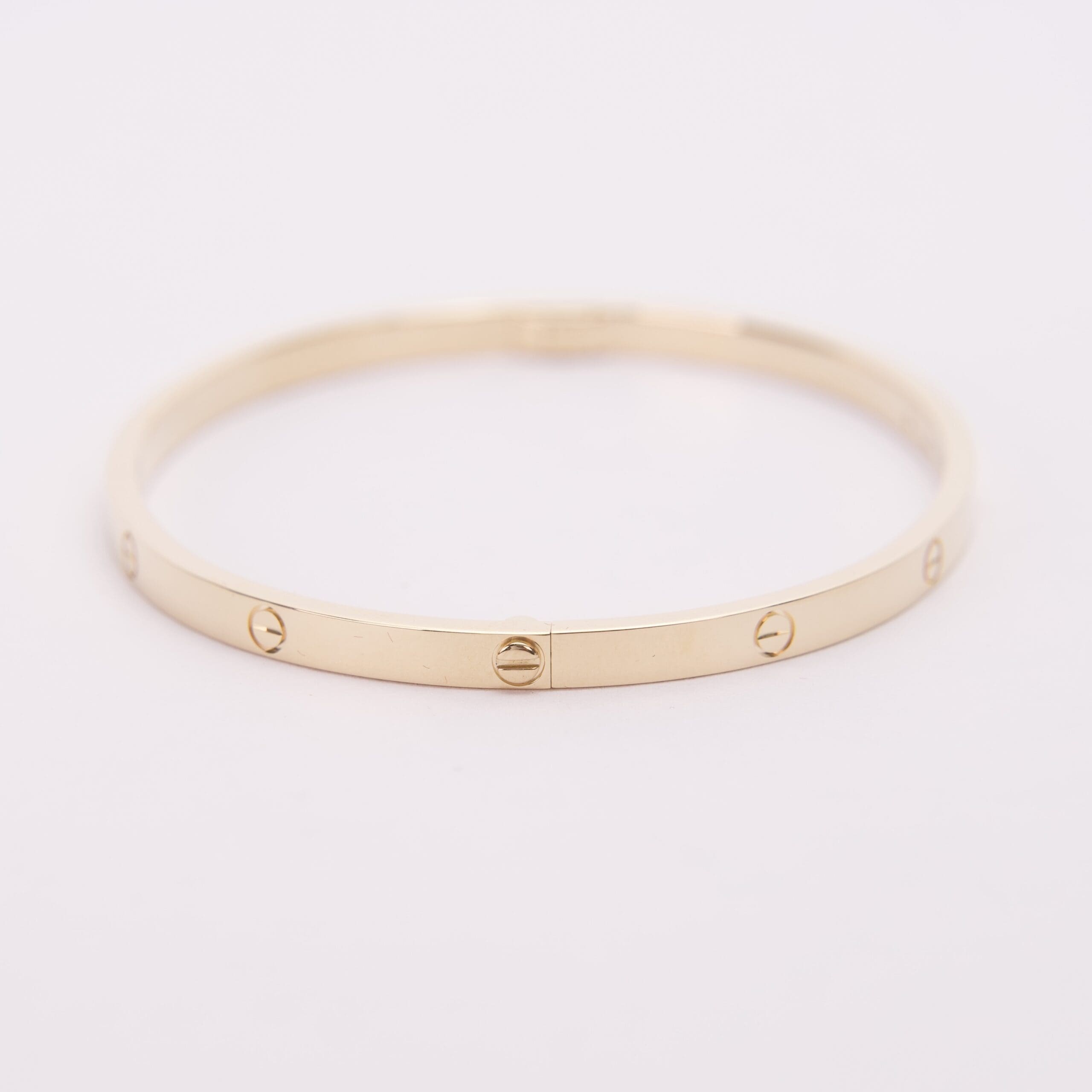 Gold bracelet with screw motifs.