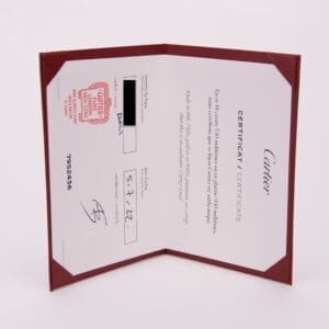 Cartier certificate in red holder, open.