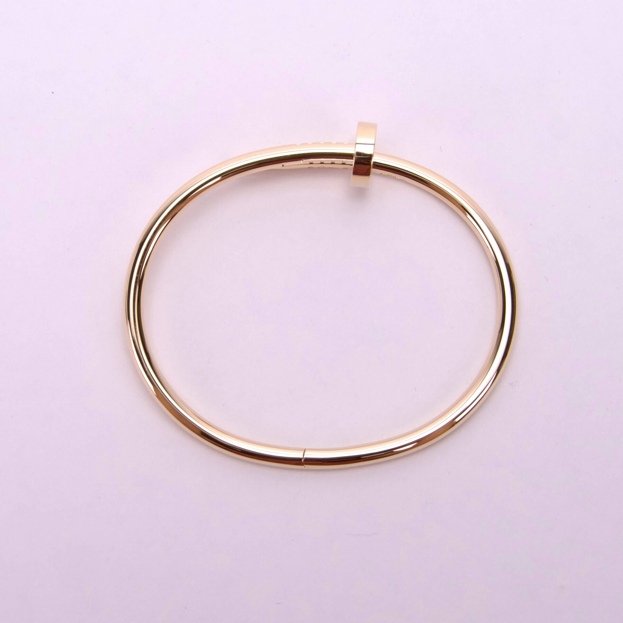 Gold bracelet on a light background.