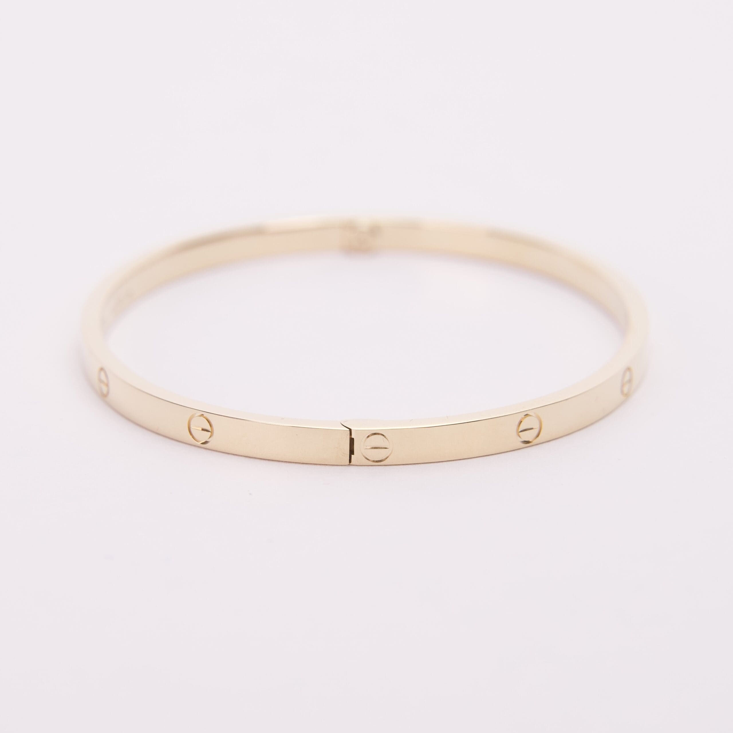 Gold bracelet with screw motif design.