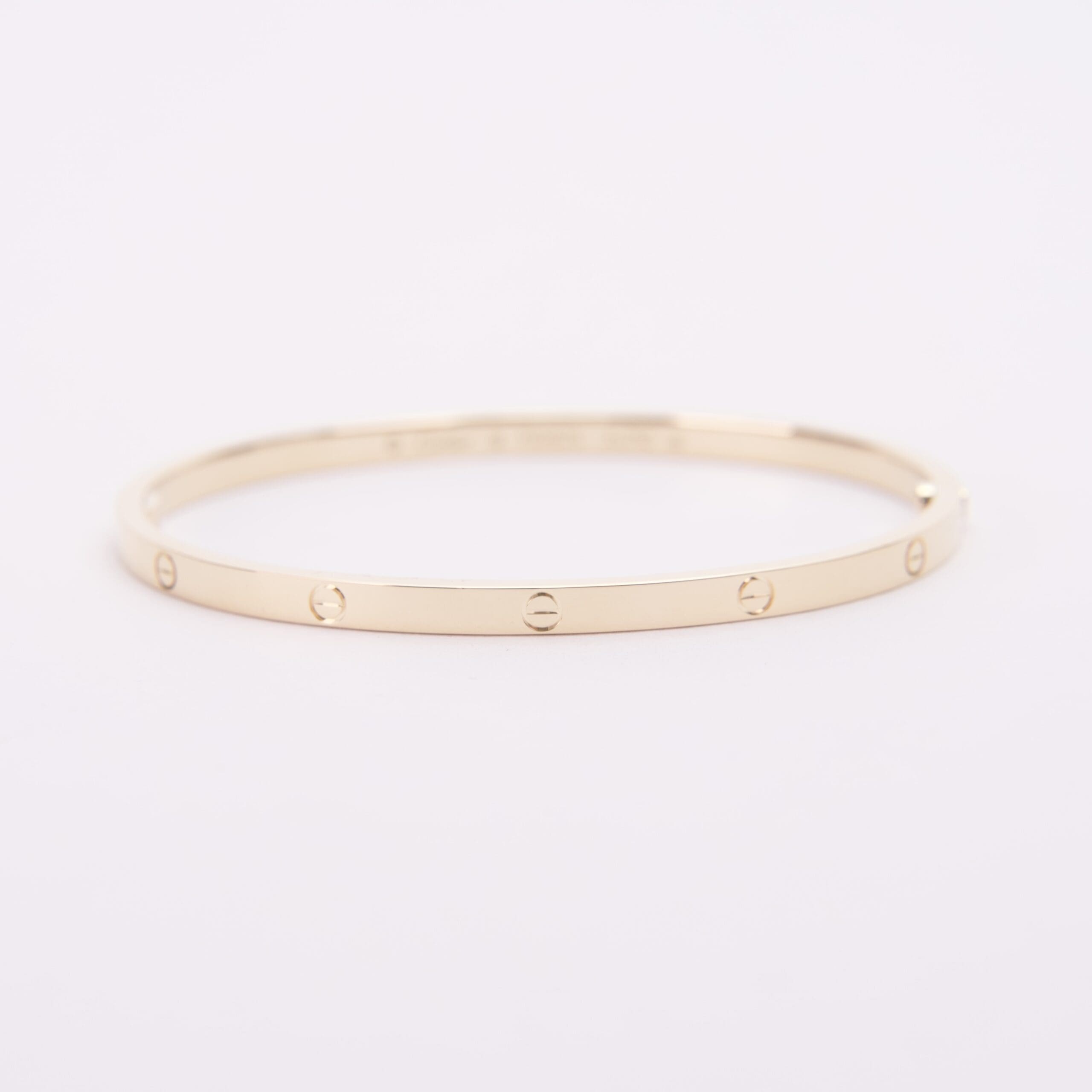 Gold bracelet with engraved circular motifs.