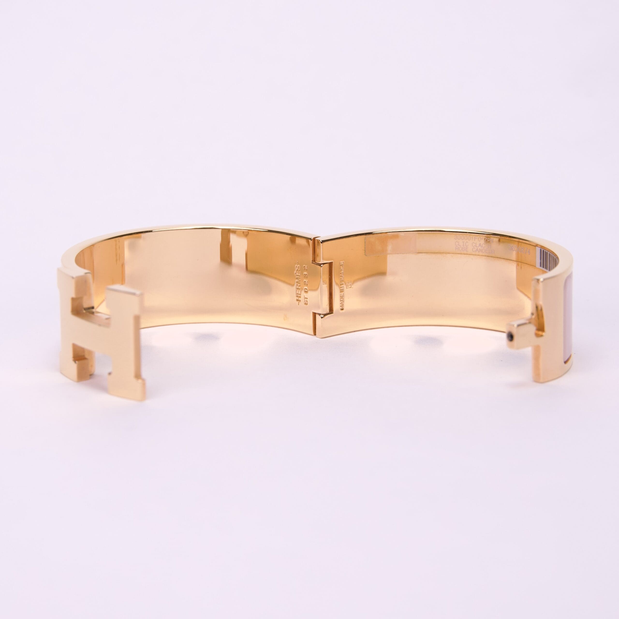 Gold bracelet with H-shaped clasp.