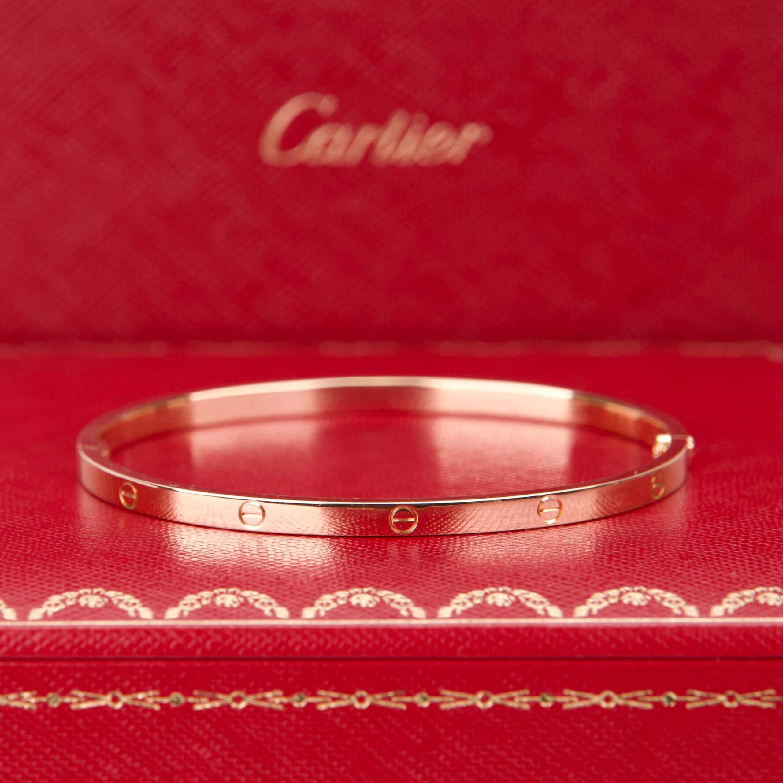 Gold bangle on red Cartier box.