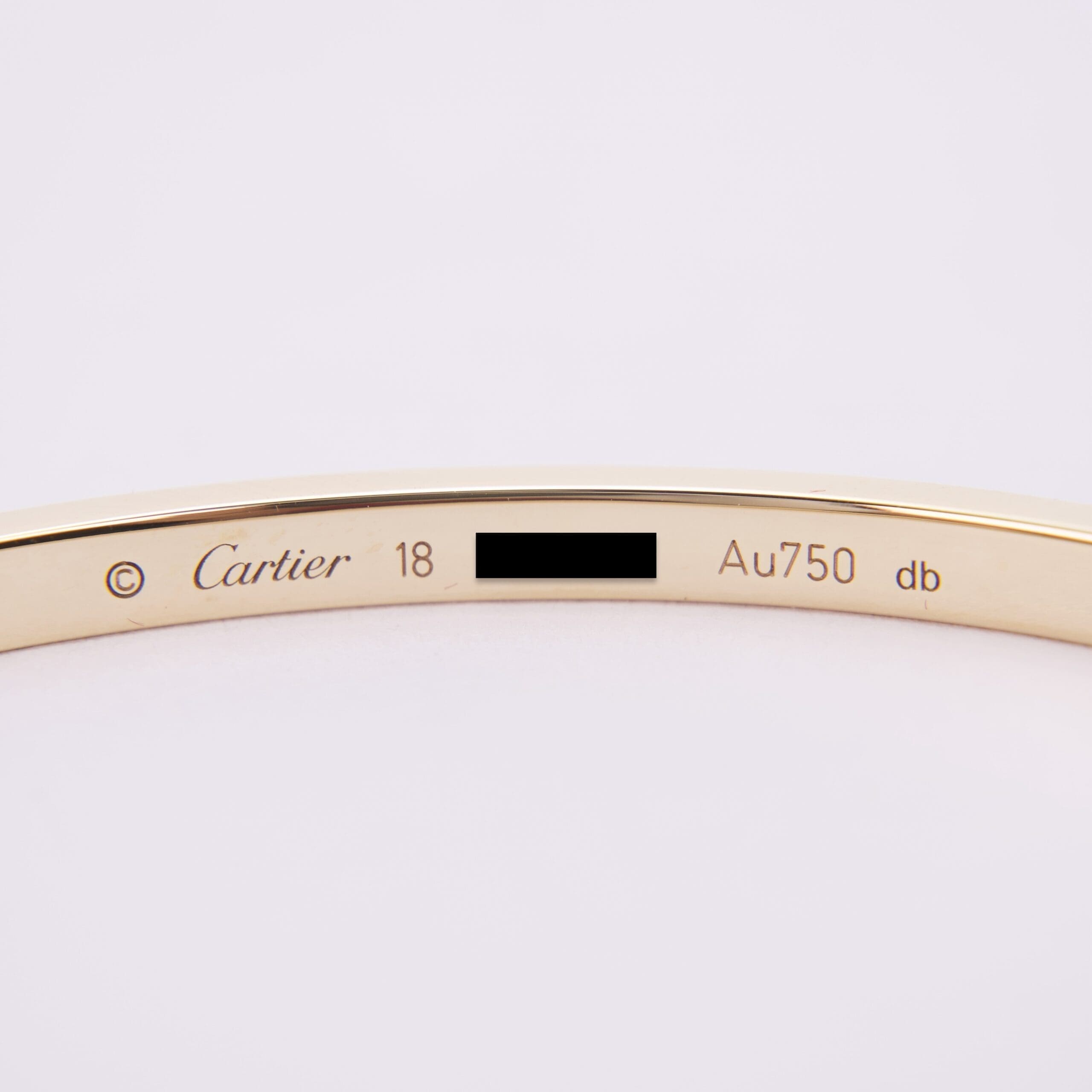 Gold Cartier bracelet with engraved details.