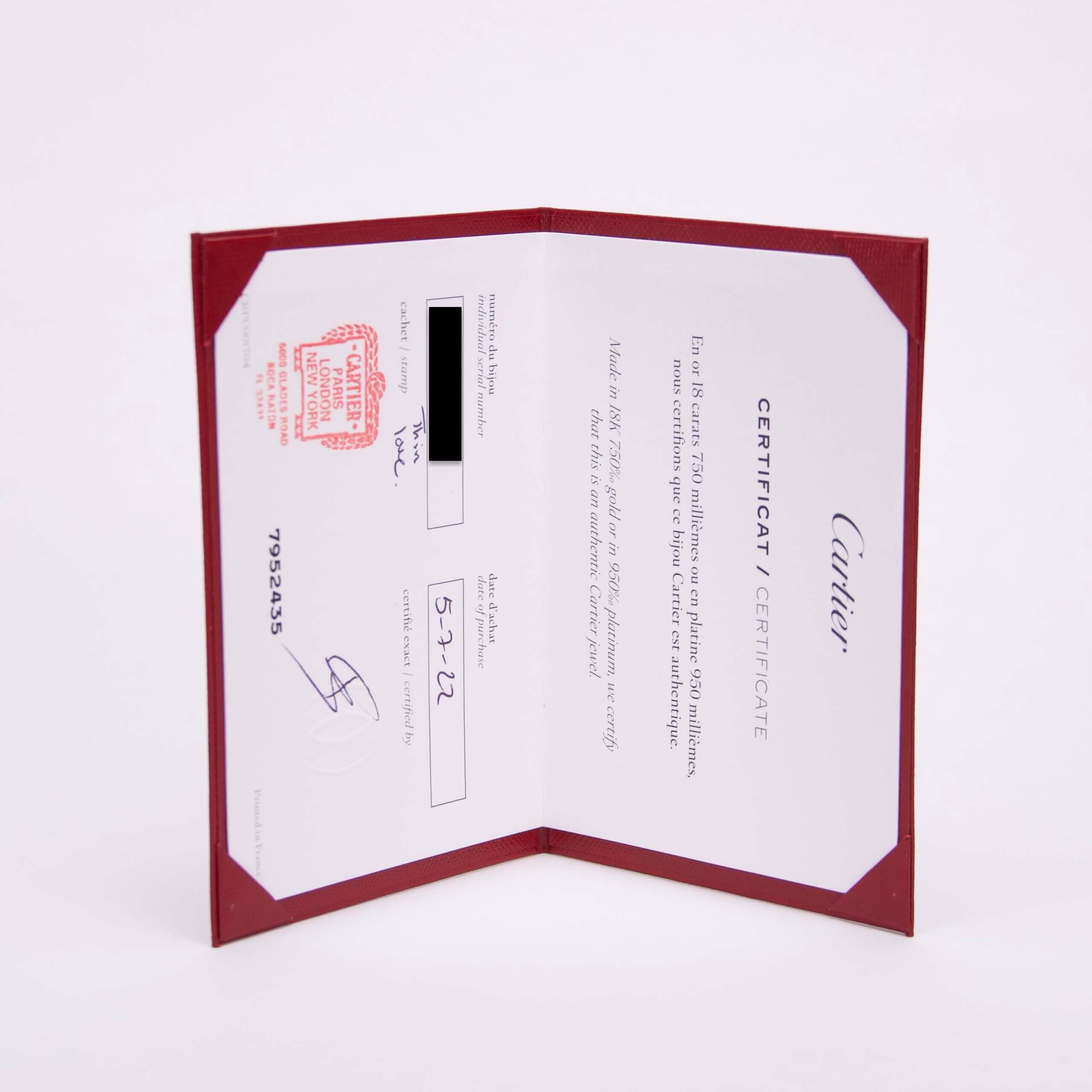 Red-bordered Cartier certificate with text and stamp.