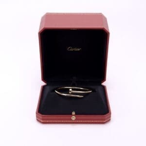 Gold bracelet in red jewelry box.