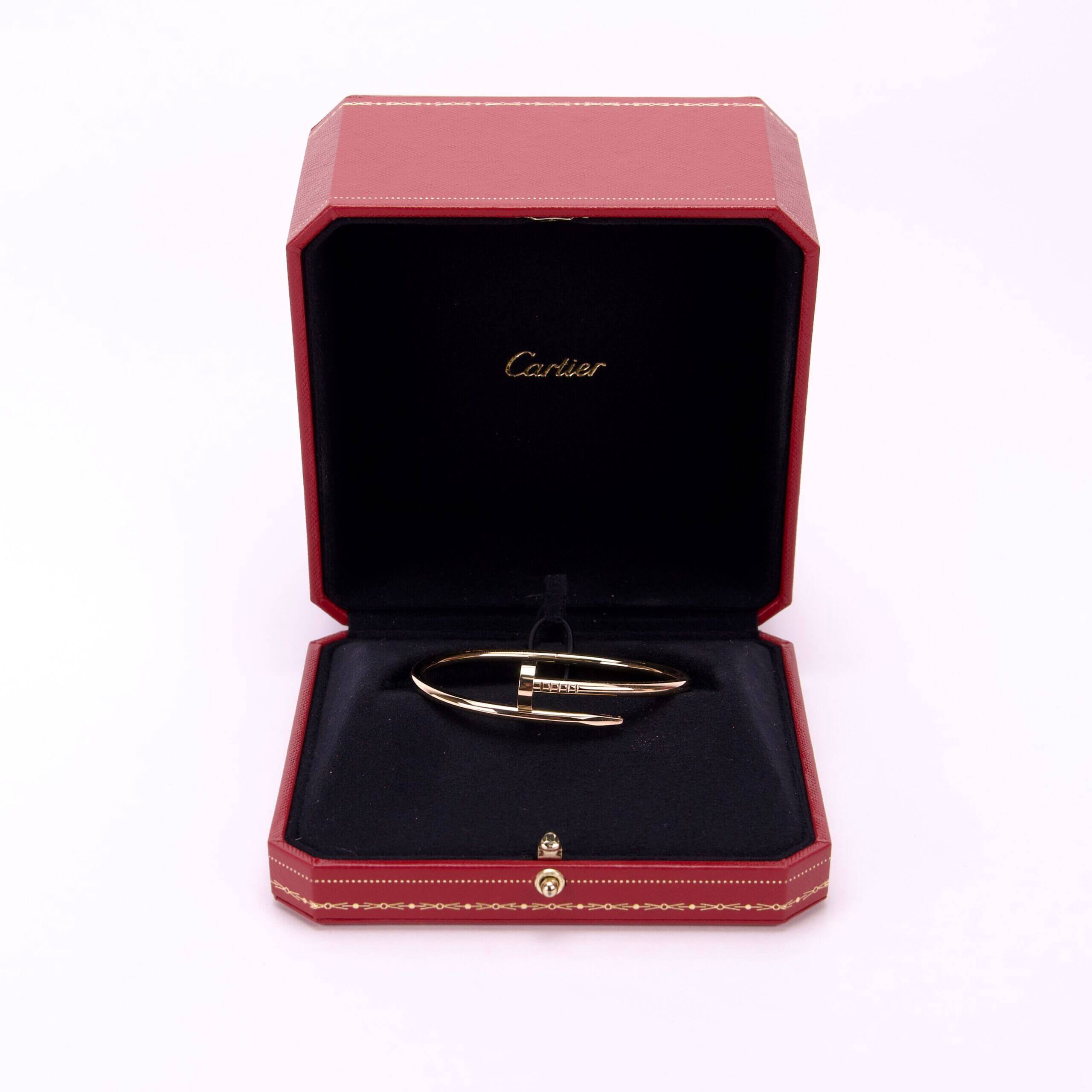 Gold bracelet in red jewelry box.
