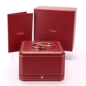 Red Cartier box with bracelet and booklet.