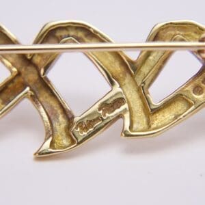 Gold brooch with intricate engravings and design.