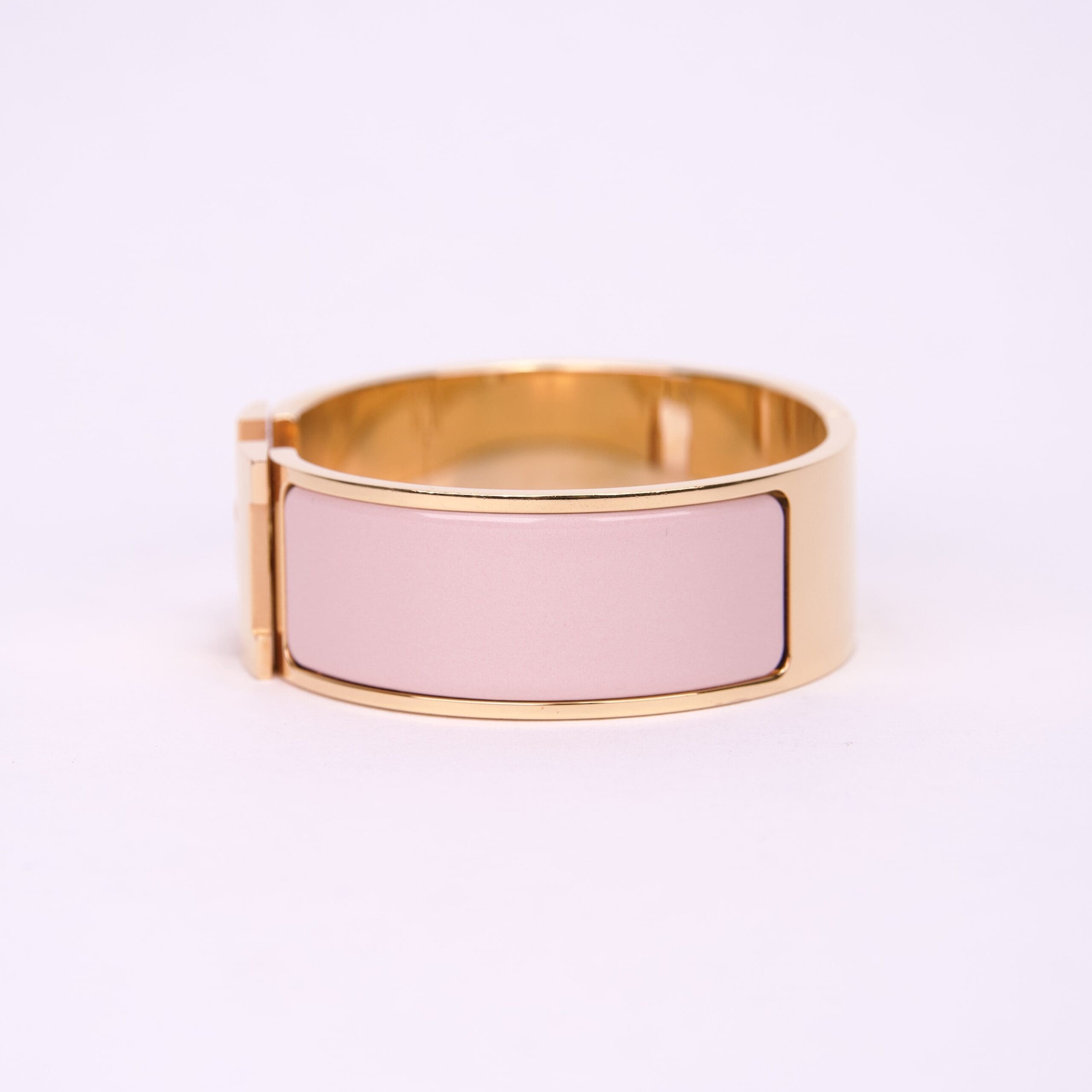 Gold bracelet with pink enamel inlay.