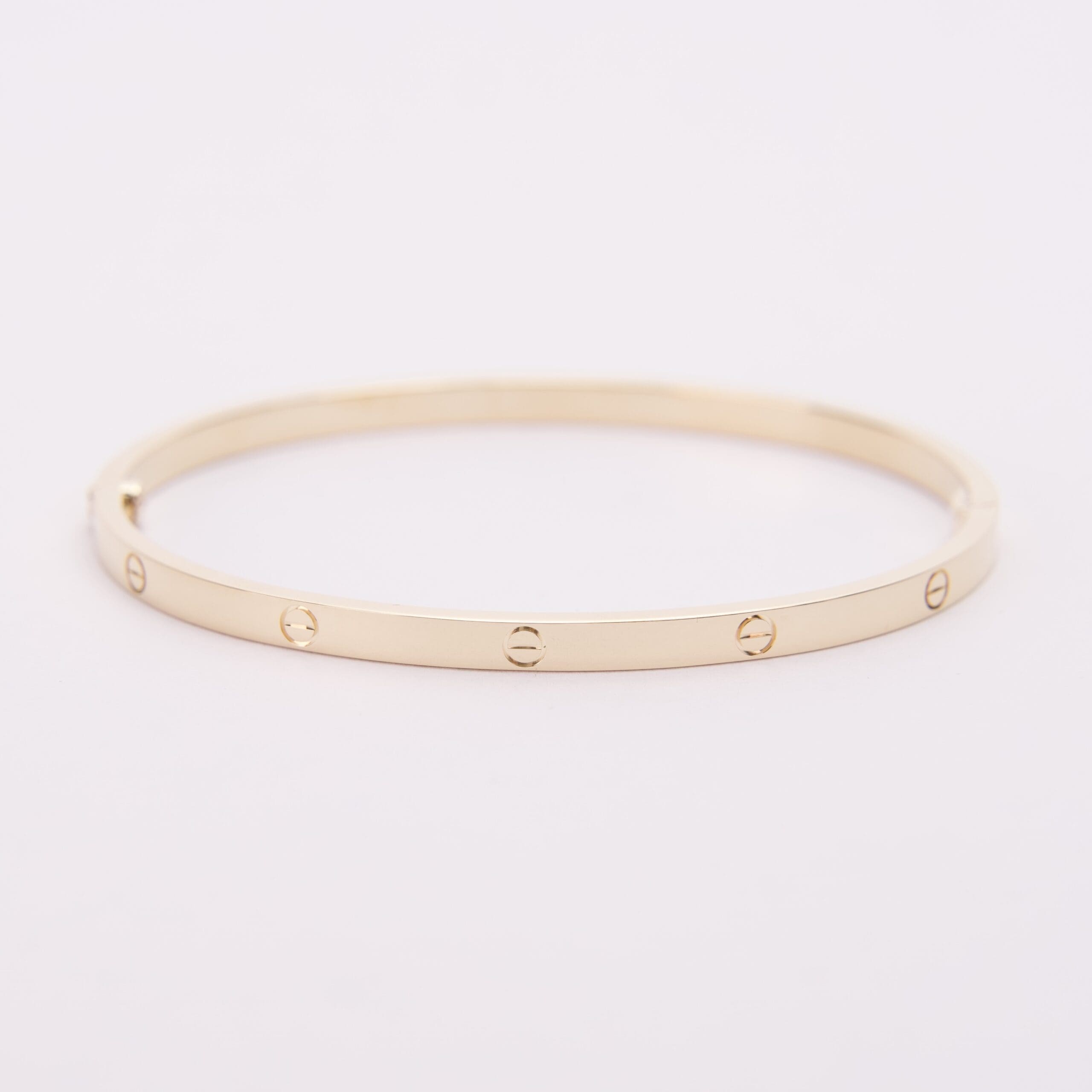 Gold bracelet with engraved screw motifs.