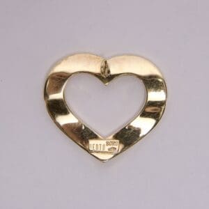 Gold heart-shaped metal object on display.