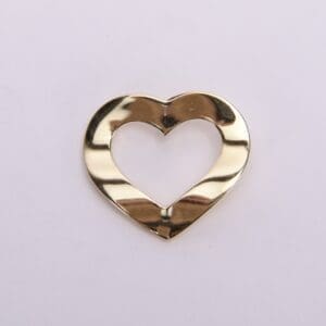 Gold heart-shaped metallic cutout on white.