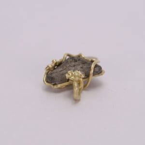 Gold wire-wrapped stone pendant with flowers.