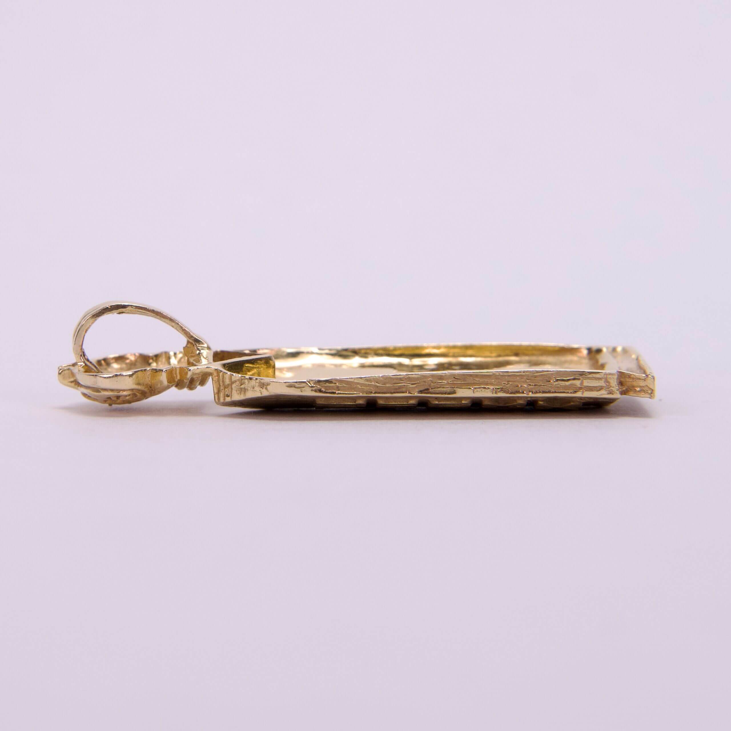 Gold rectangular pendant with loop attachment.
