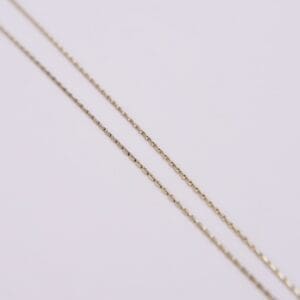 Gold chains on a light background.
