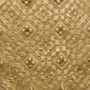 Gold textured pattern with intricate geometric design.