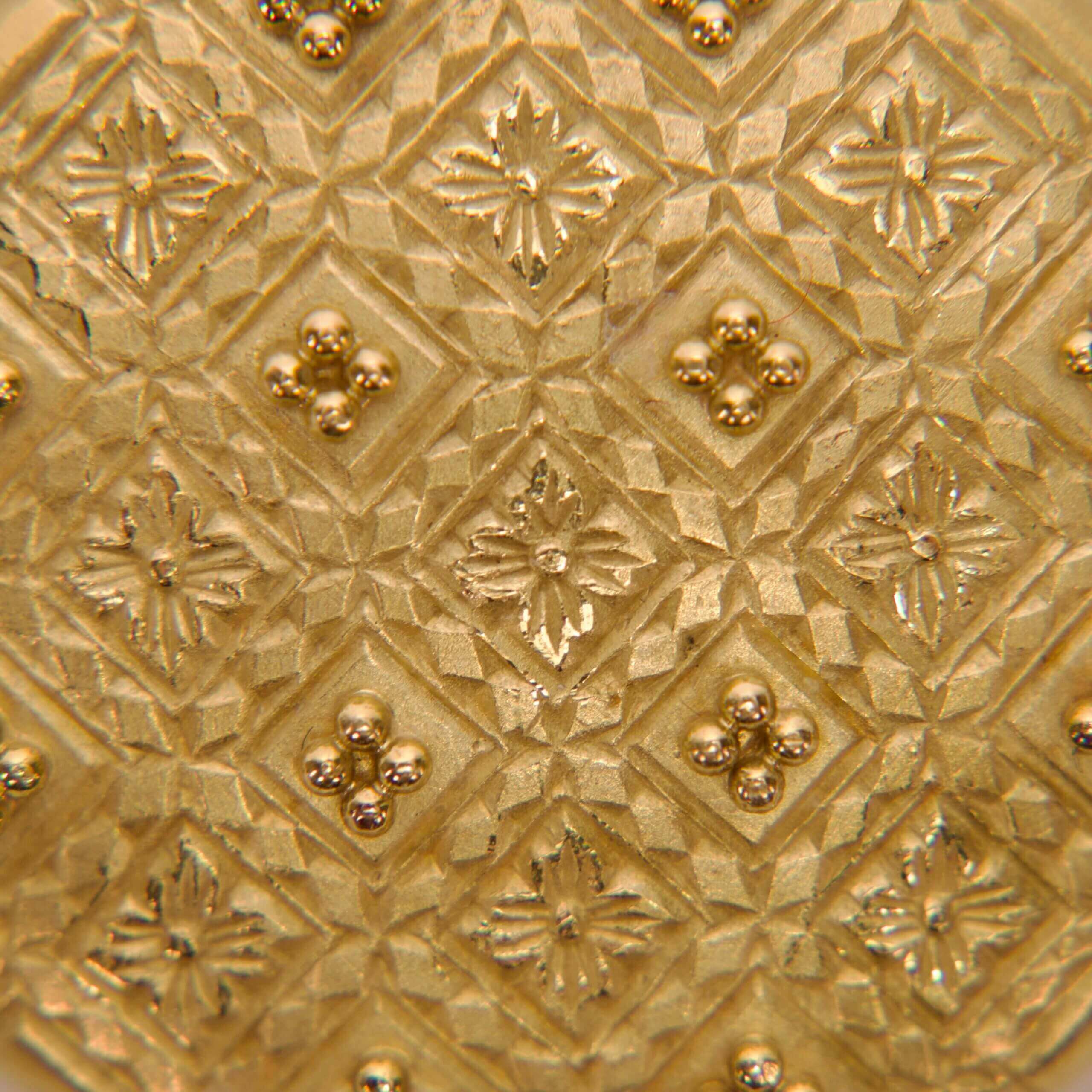 Gold textured pattern with intricate geometric design.