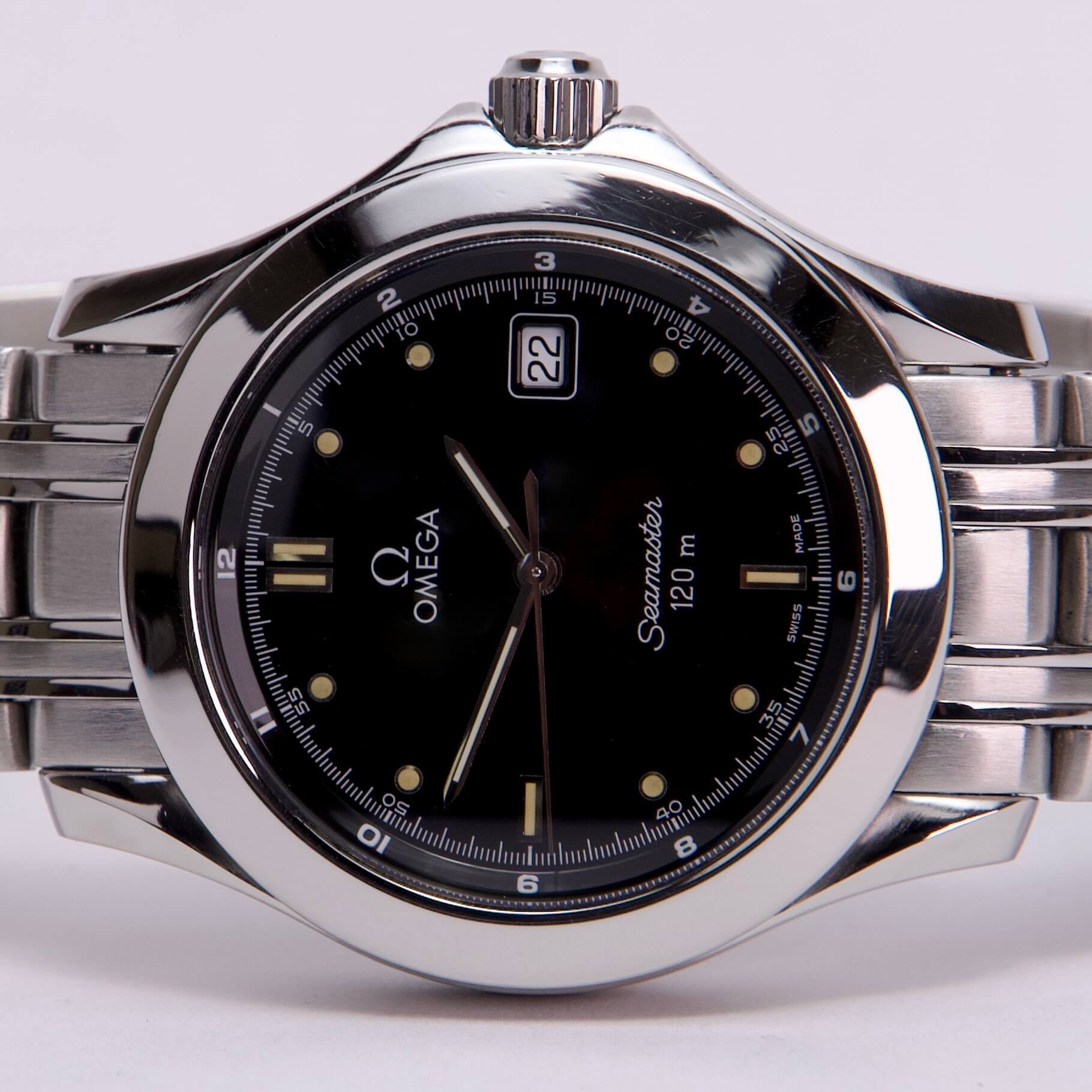 Silver Omega Seamaster watch with black dial.