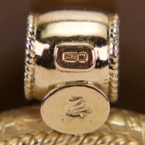 Gold ring with engraved hallmark details.