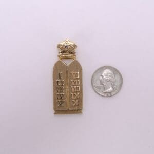 Golden Torah pin with crown, next quarter.
