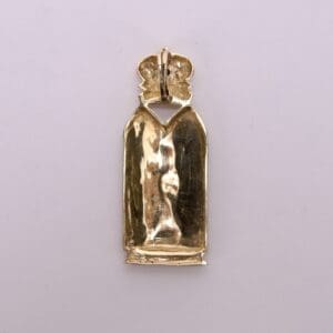 Gold pendant with crown design, back view.