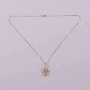 Gold necklace with decorative pendant.