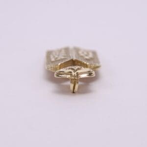 Gold-colored ring with intricate design details.