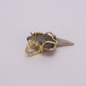 Gold and stone jewelry piece on display.