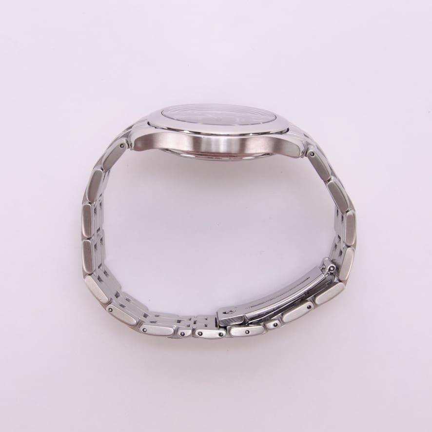 Silver wristwatch with metal bracelet side view.