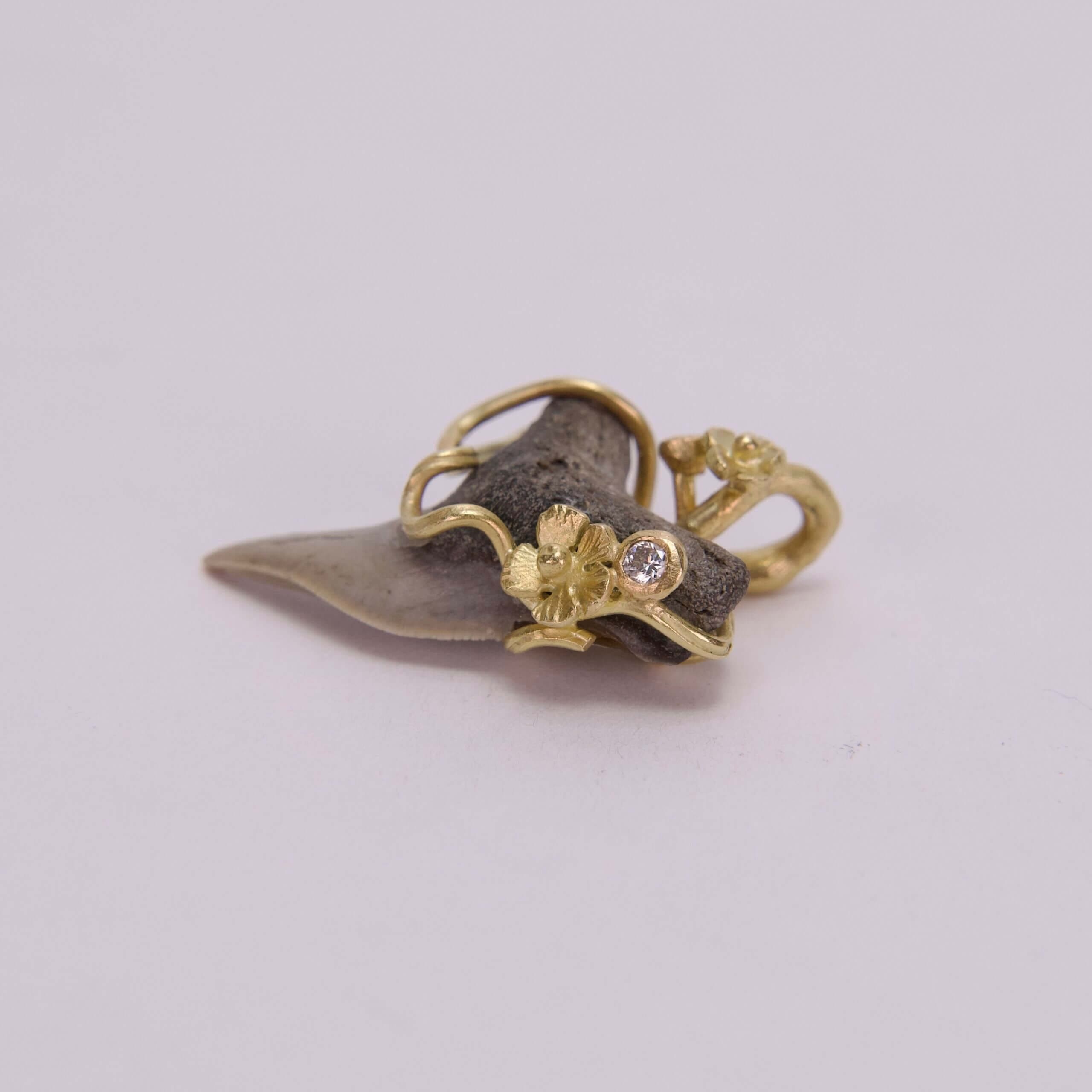Gold-accented shark tooth pendant with diamond.