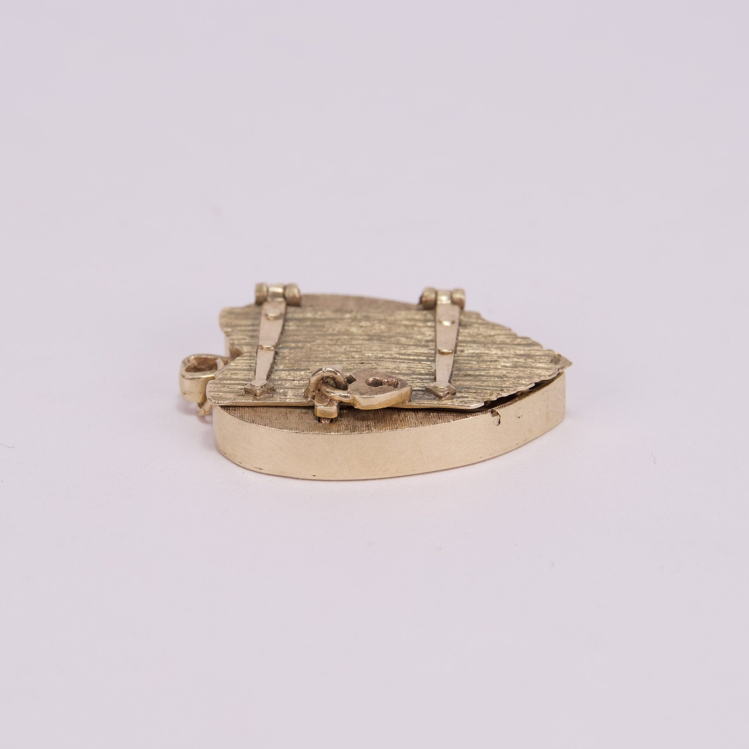 Gold heart-shaped locket on white background.