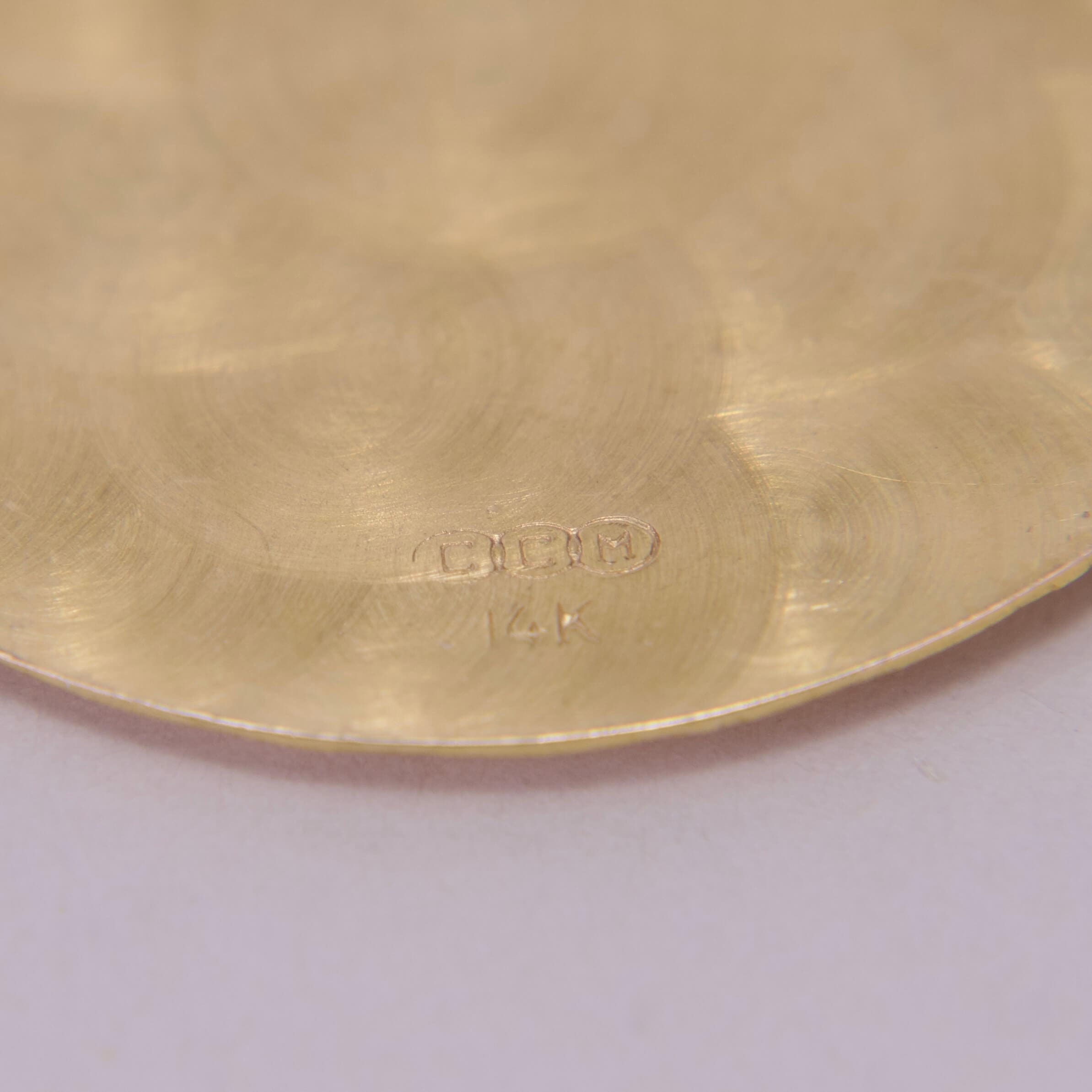 Close-up of gold surface with markings.